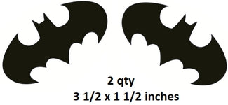 Two black bat-shaped stickers with size specifications on a white background